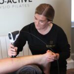 Physiotherapist at Pro-active shockwaving calf for plantarfascitis patient.