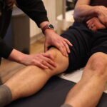 Image of physio at pro-active treating a knee injury.